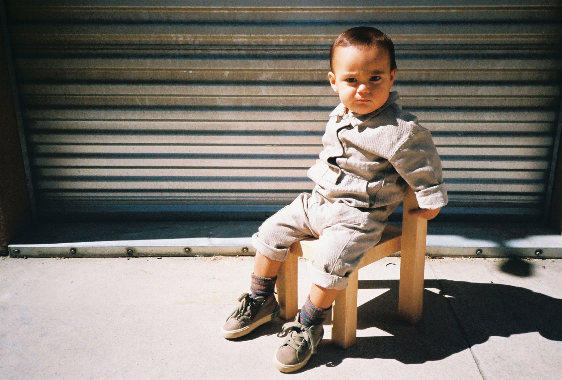 Child sitting on the Natural finish Child's Anything Chair shot outside