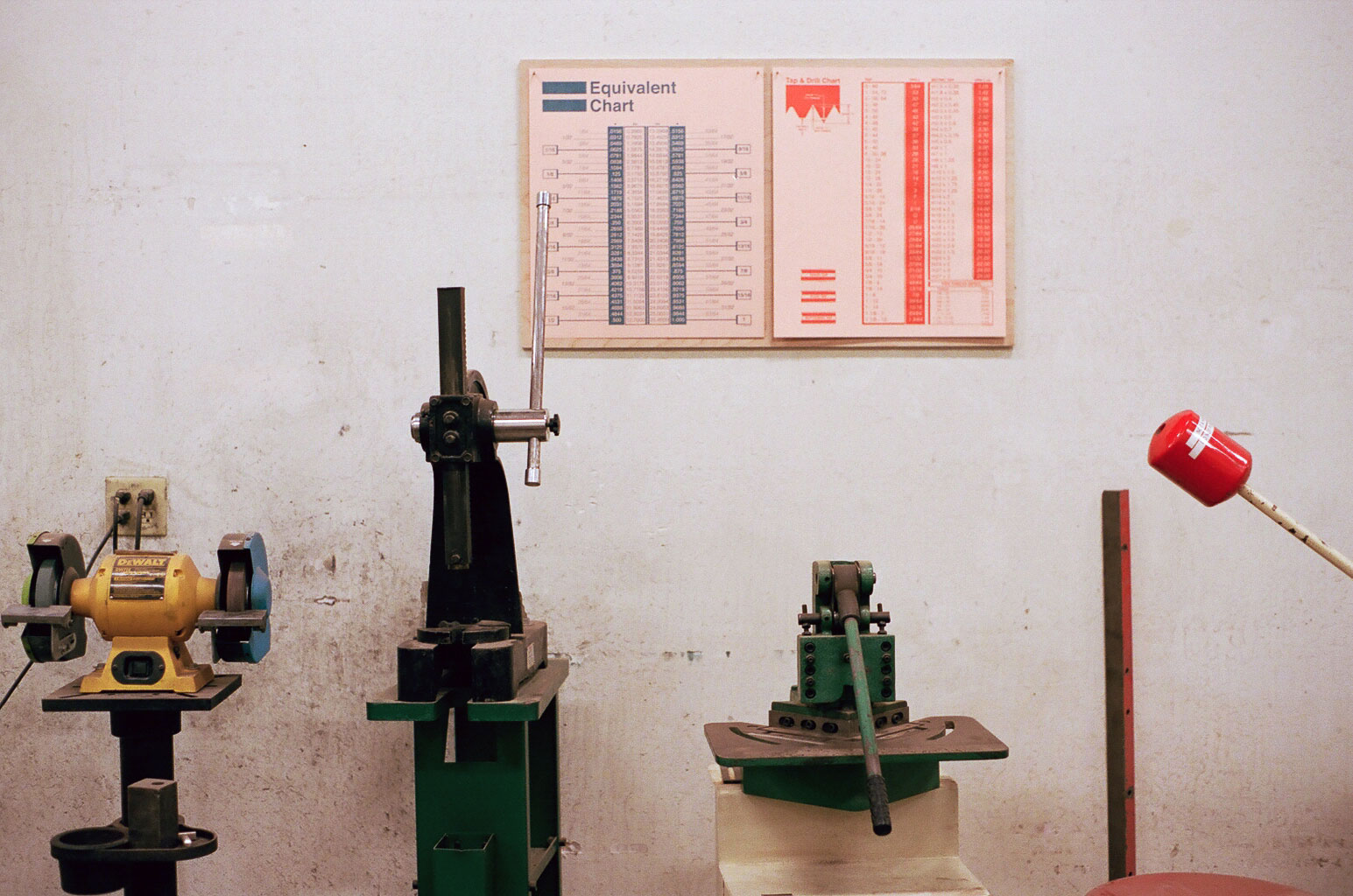 Information Charts hanging mounted to plywood in the workshop