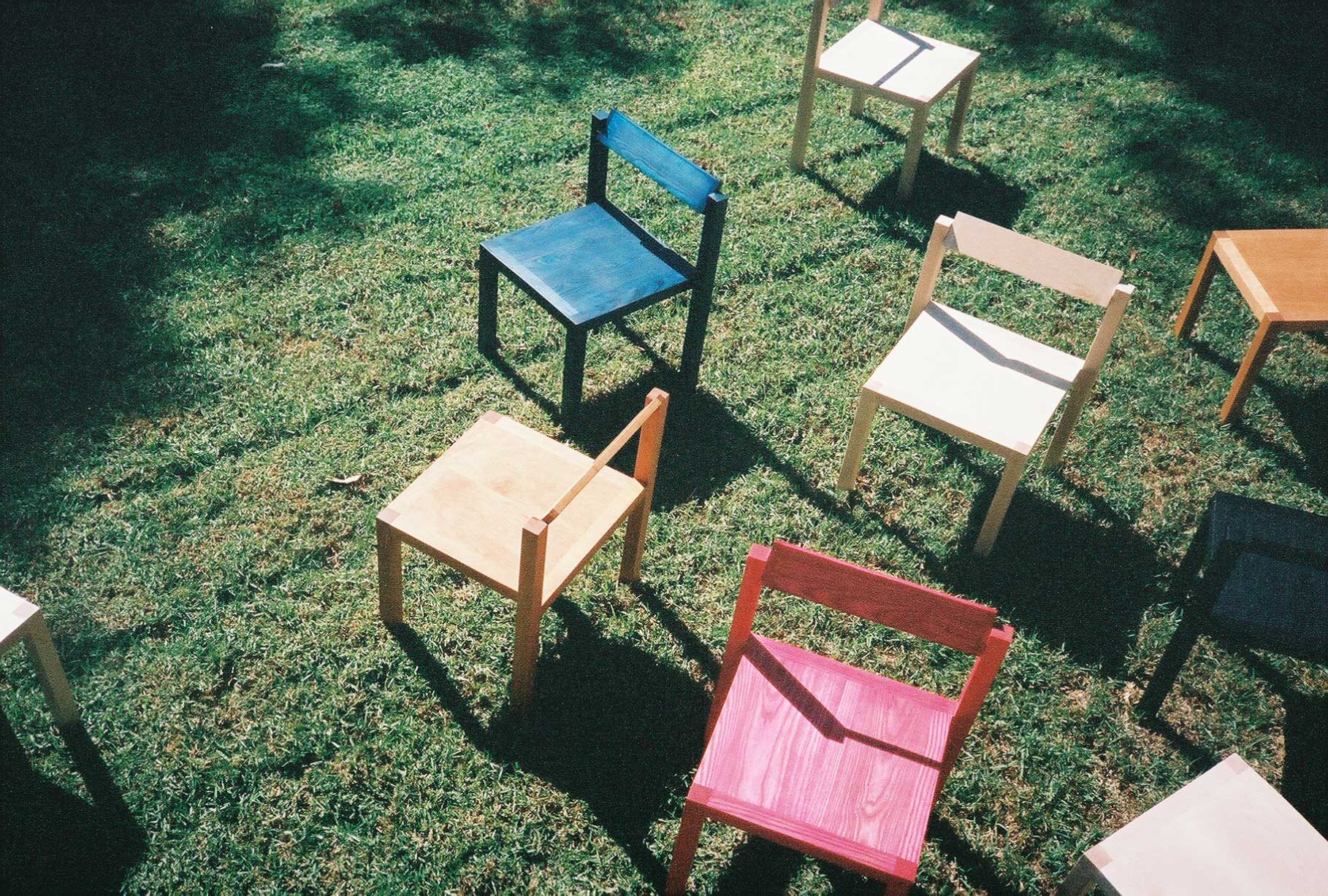 Anything Chairs in different finishes arranged in the grass