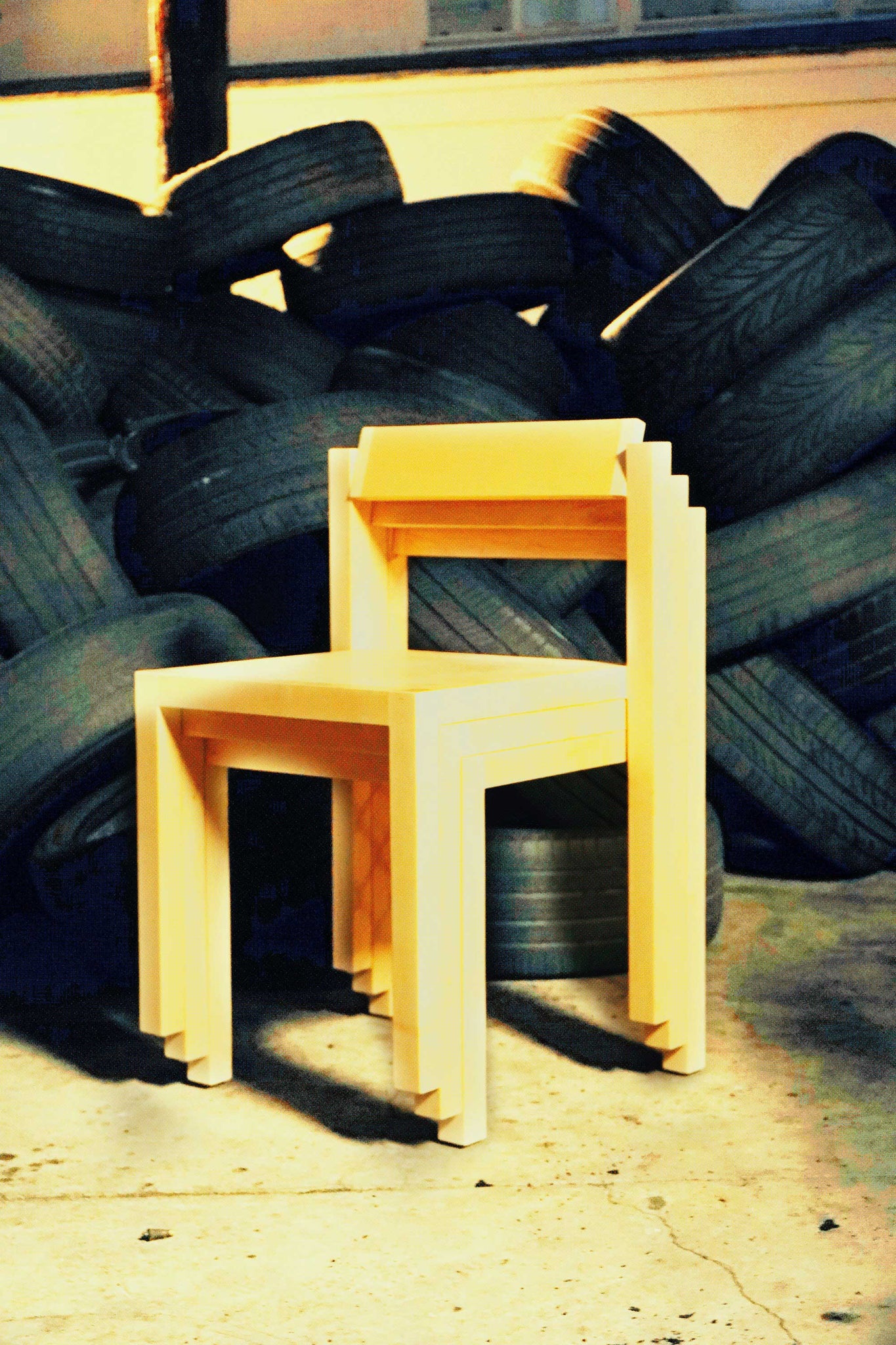 A stack of Anything Chairs shot in front of a pile of tires