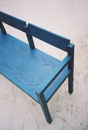 Close-up of the grain on the Blue Anything Bench shot outside on the patio