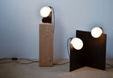 Bloop Floor Lamp  and bloop table lamp on a wood pedestal shot on a wood floor.