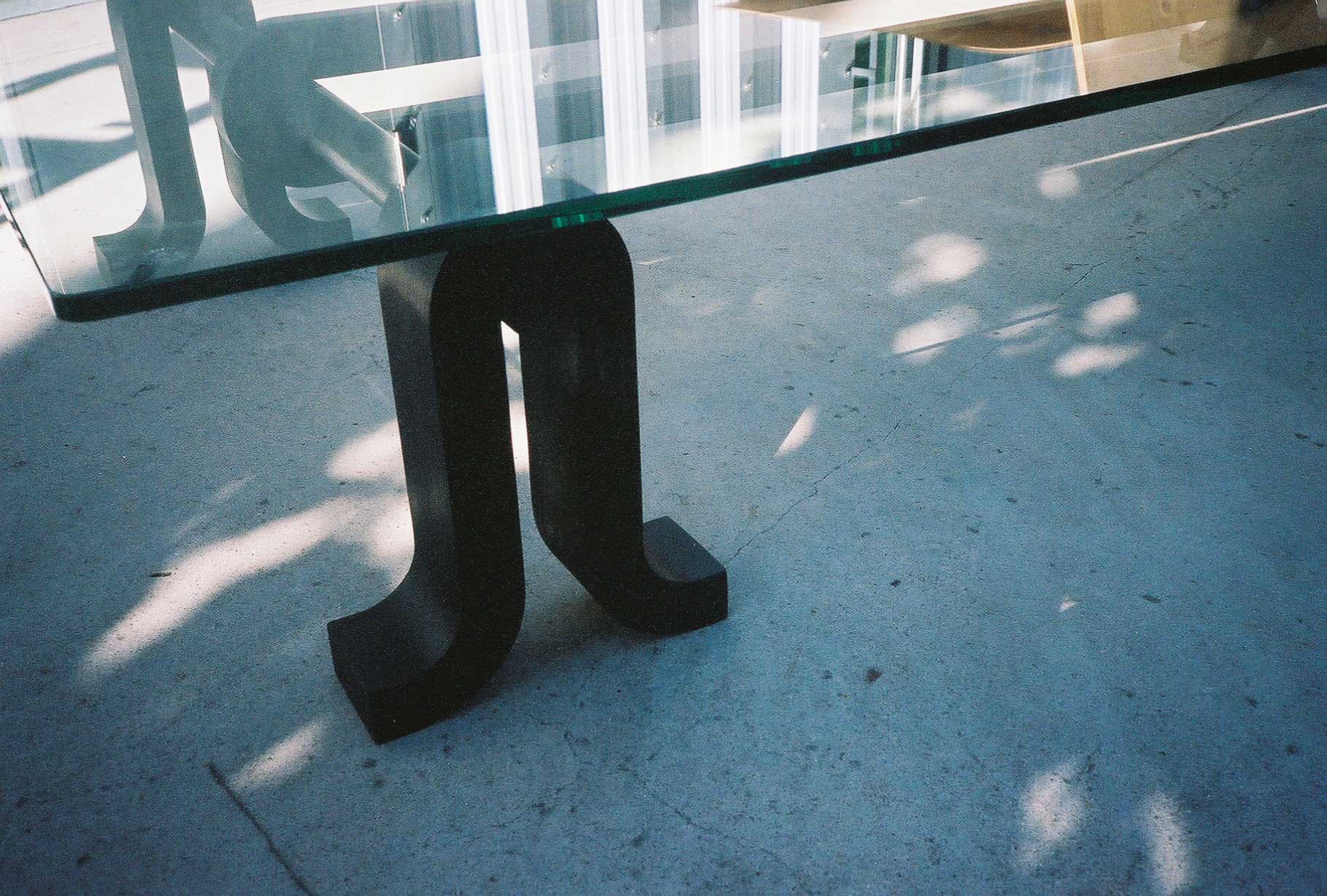 Close up of Loop Table leg in black on the concrete