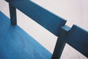 Close-up of the swivel back on the Blue Anything Bench shot outside on the patio