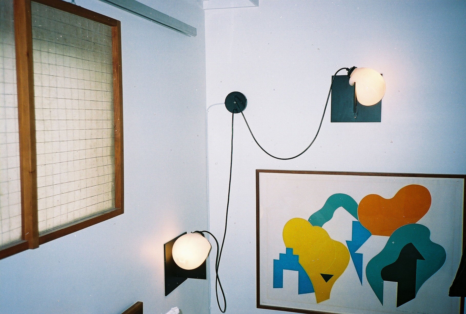 Bloop Sconce mounted on the wall in the corner