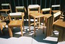 Close-up shot of many Anything Chairs and Anything Counter Stools stacked and arranged out on the patio.