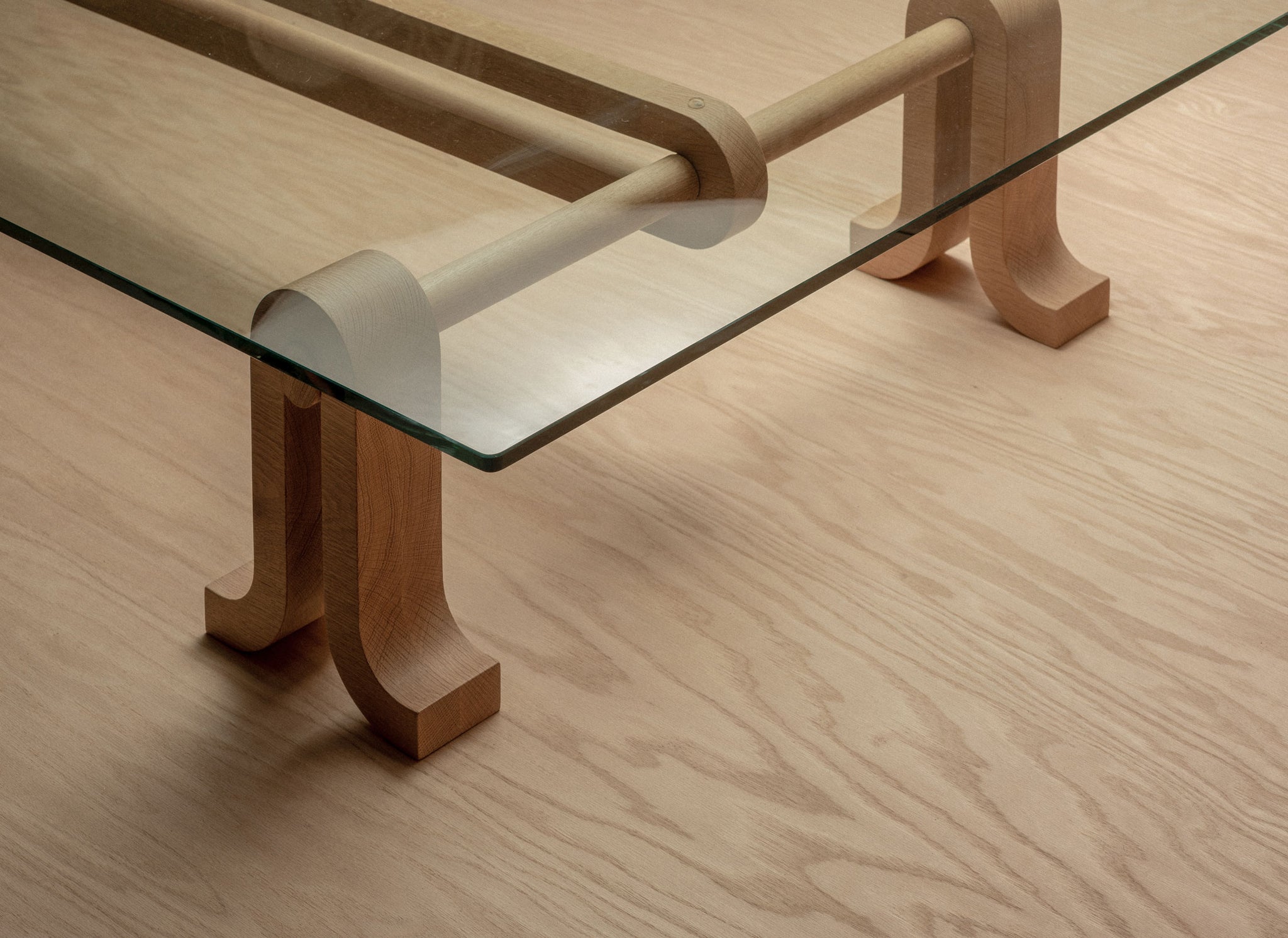 Close-up of the Loop Table in a natural finish on a plywood floor