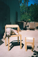 Child climbing onto the Anything Chair next to the Child's Anything Chair shot outside